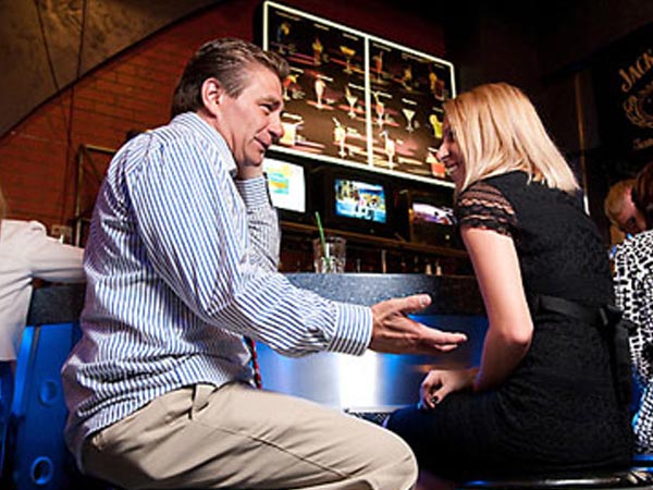 A Man talking to a Ukrainian girl at the bar.