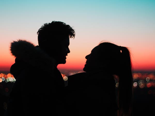 silhouette of man and woman in the sunset