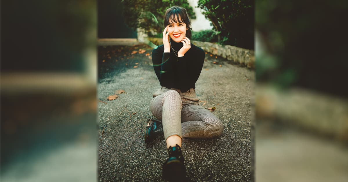 A photo of a beautiful Ukrainian woman sitting sitting down on the ground